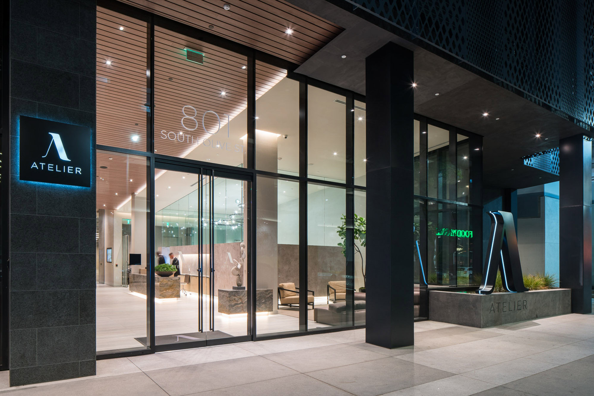The front glass door to Ateliers luxury high rise apartments in downtown Los Angeles CA