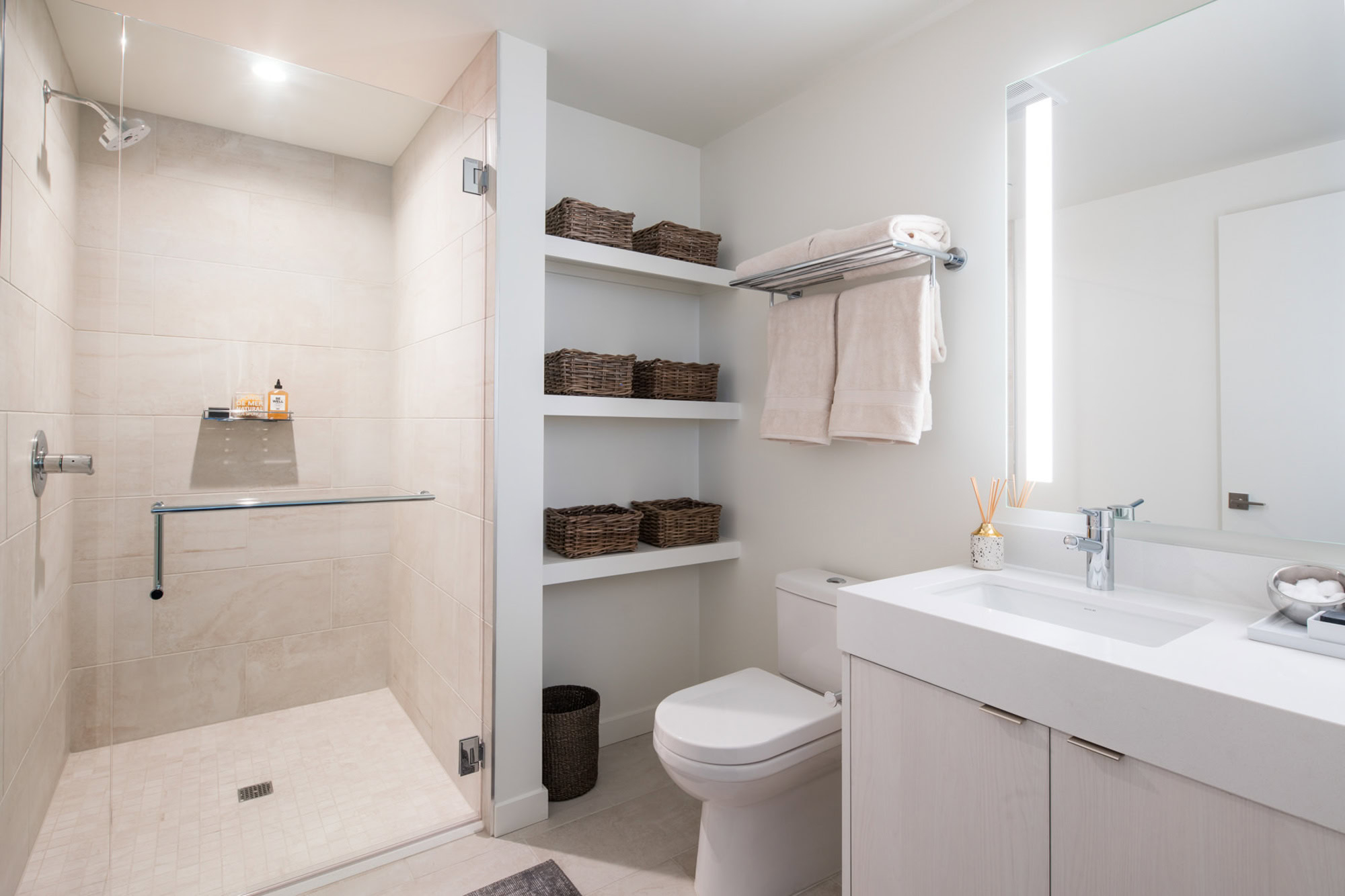A spacious, spa-like bathroom with ample storage space at Ateliers luxury apartments in downtown LA