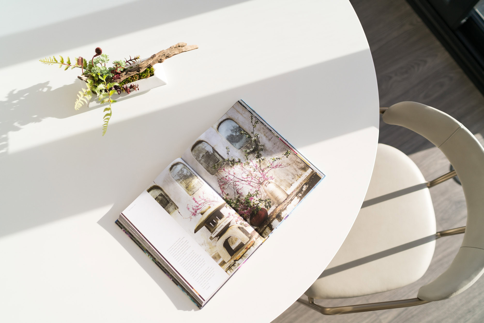 A dining table with an open magazine on it at Ateliers luxury apartments in downtown LA