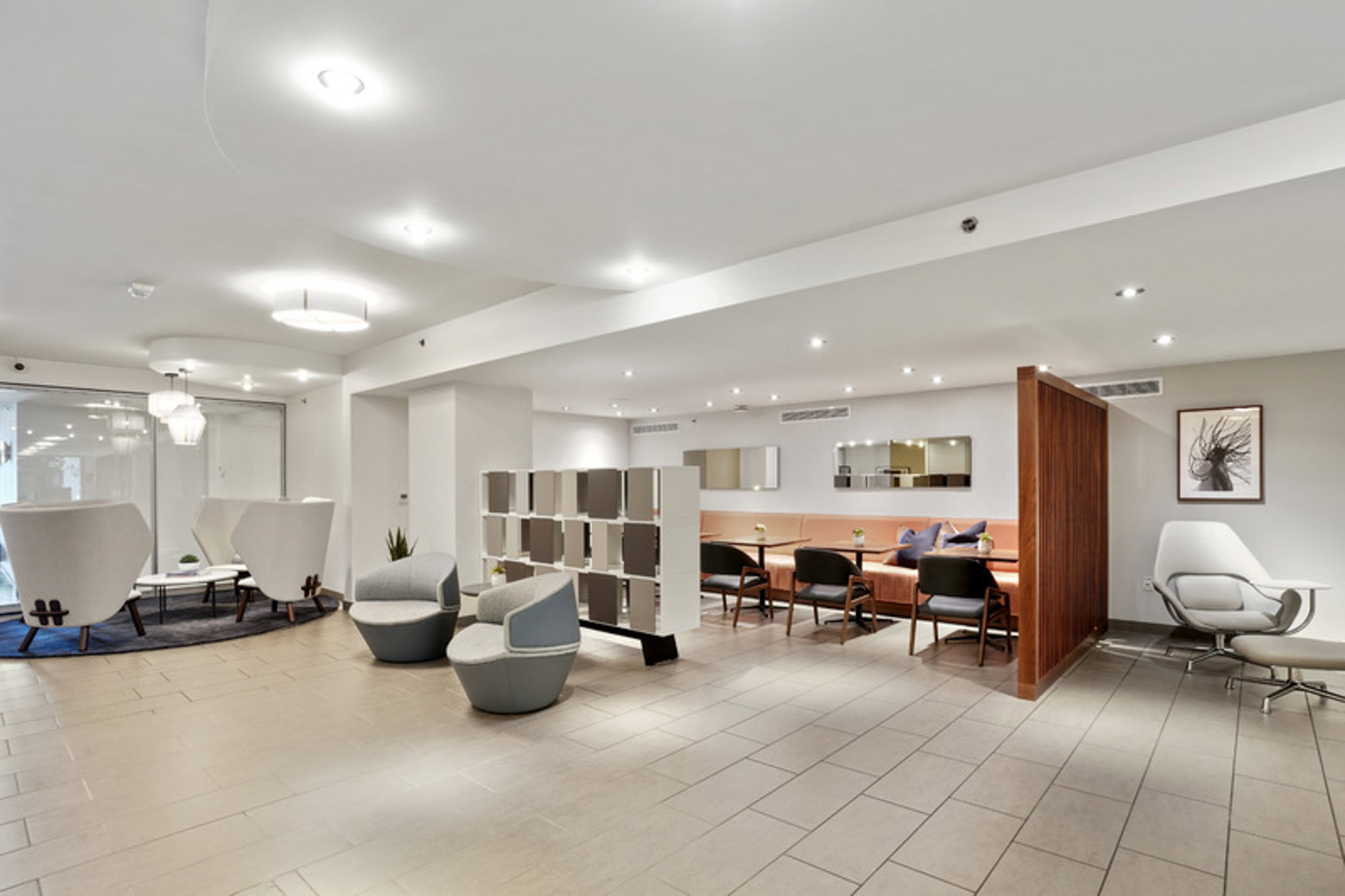 A coworking lounge with several seating areas and tables at the Mosso apartments in San Francisco