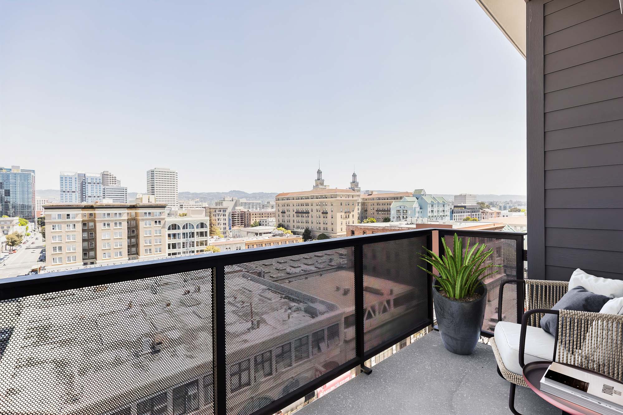 A balcony overlooking the city in an apartment ad the Webster Eleven apartments in downtown Oakland