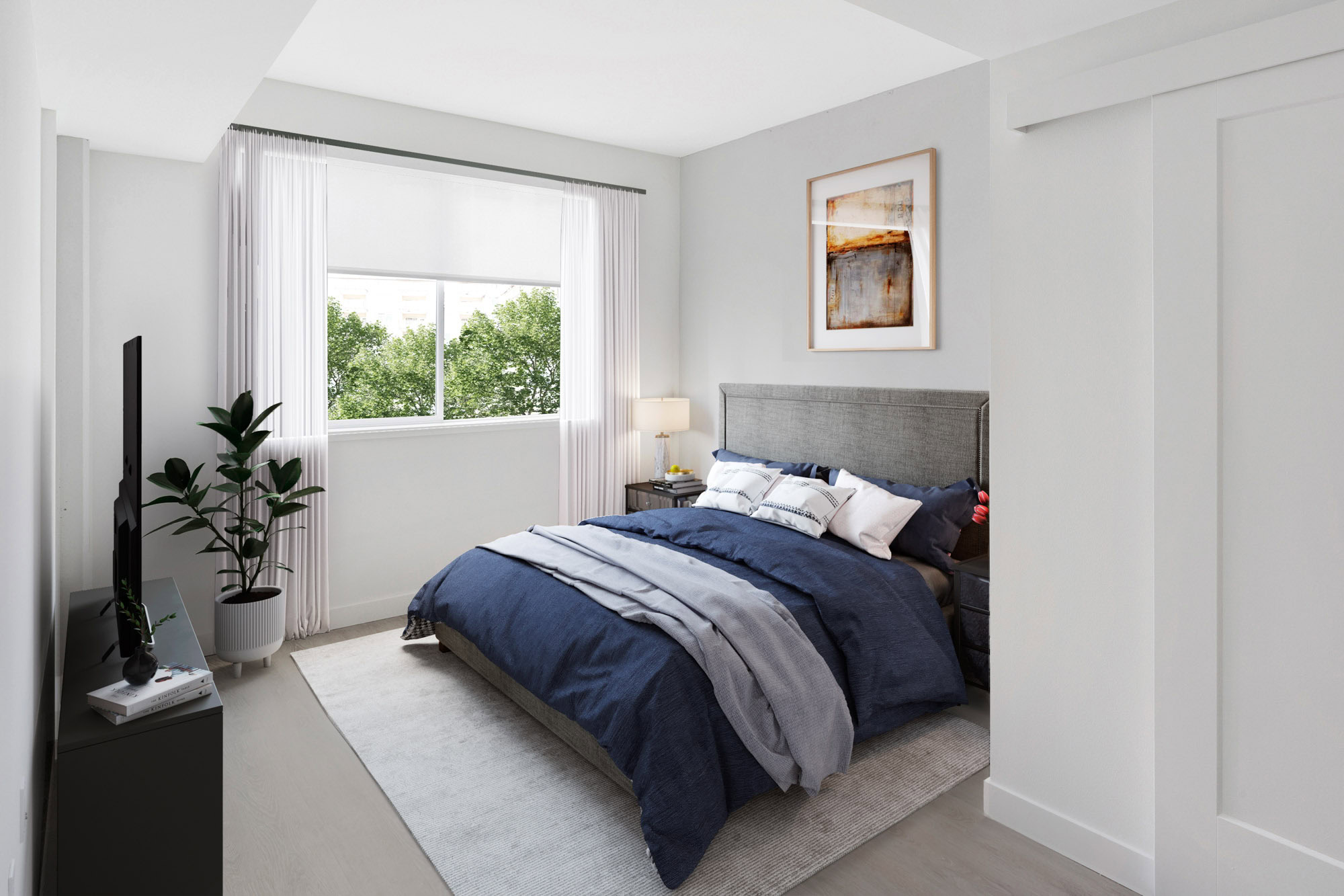 A bedroom with hardwood floors and a window at the Webster Eleven downtown Oakland apartment for rent