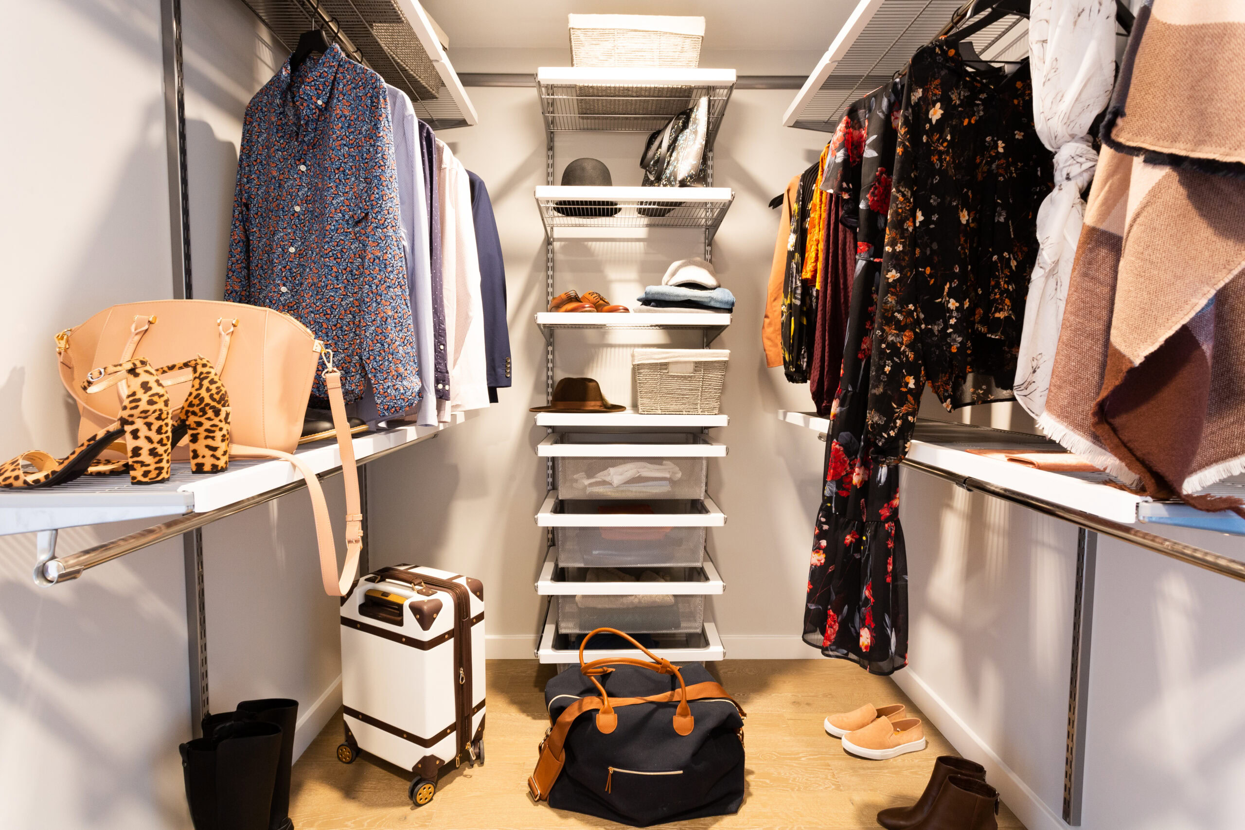 walk-in closet with clothes, shoes, accessories and luggage