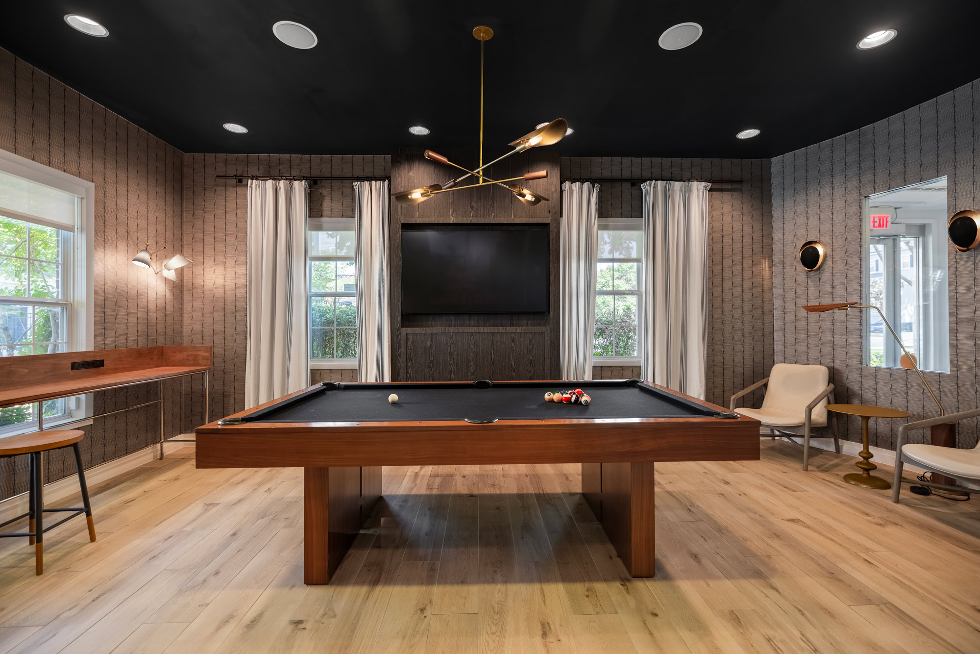 Resident lounge with billiards and seating options.