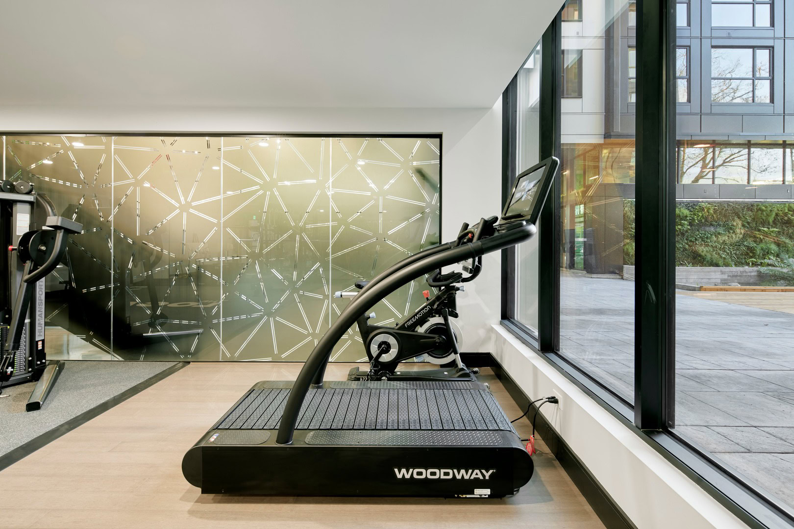 A non-motorized treadmill an a modern fitness center at The Logan apartments in Temescal, CA