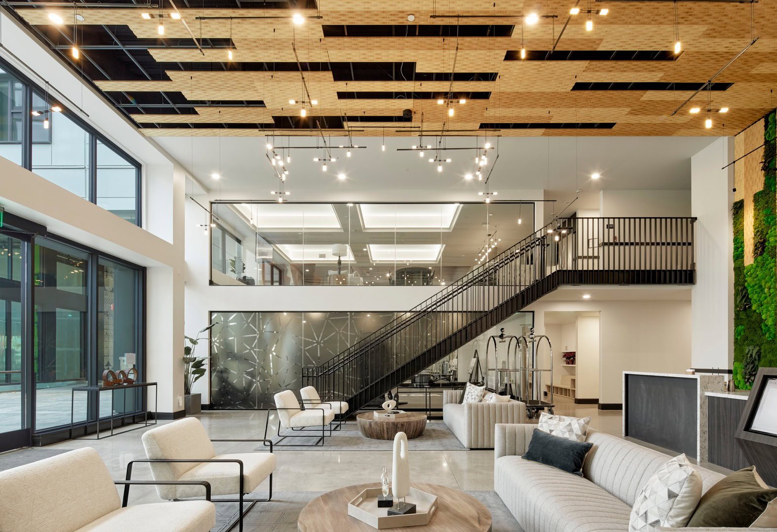 A lobby lounge with stairs leading to the coworking lounge at The Logan luxury apartments in Temescal, Oakland CA