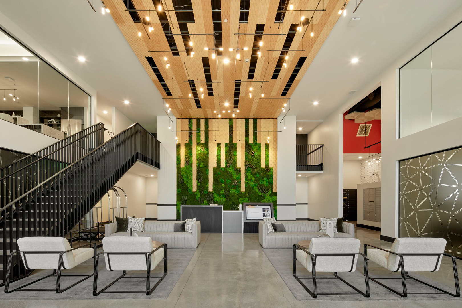 A lobby lounge with stairs leading to the coworking lounge at The Logan luxury apartments in Temescal, Oakland CA