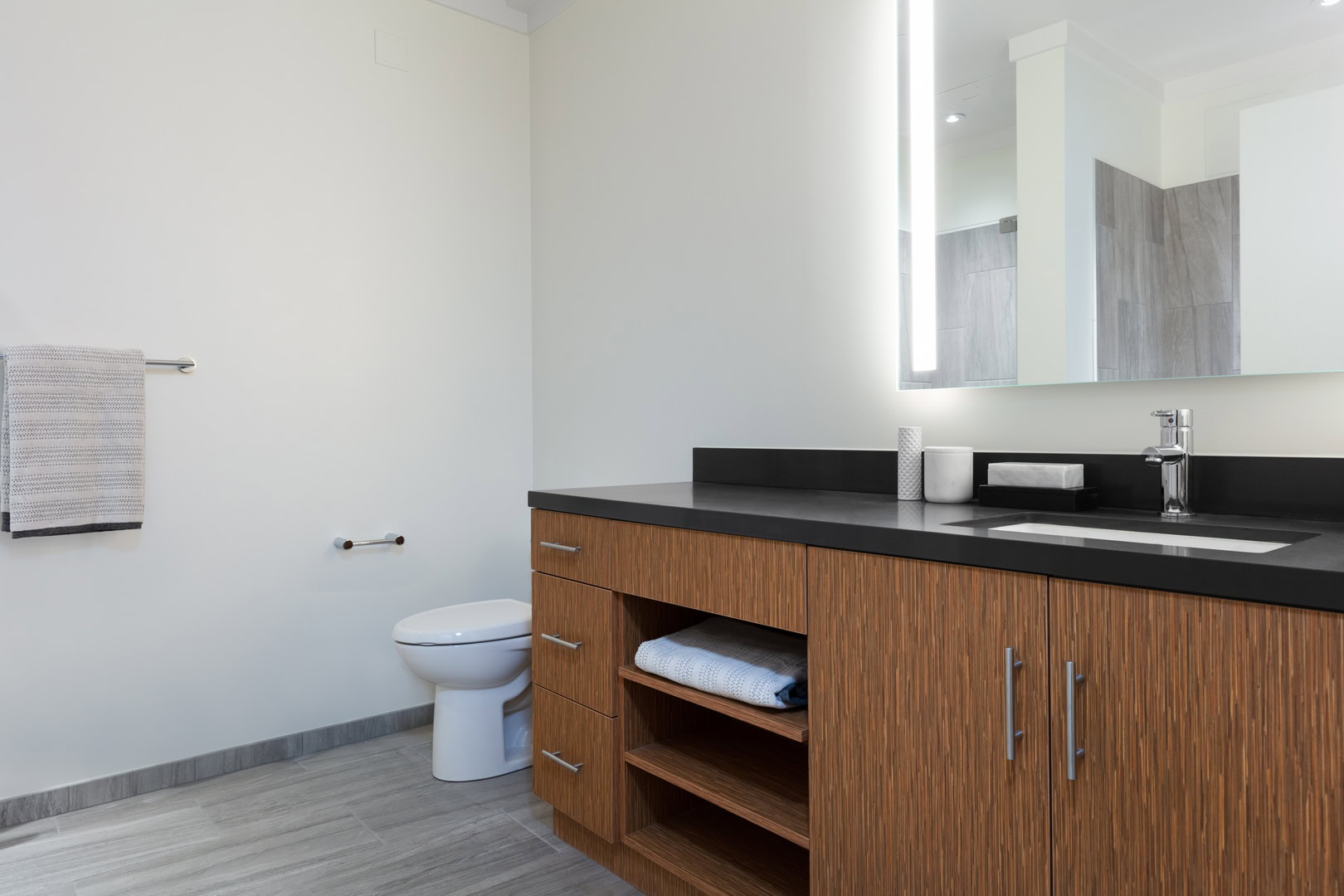 A bathroom with a large sink and vanity at The Logan apartments in Temescal