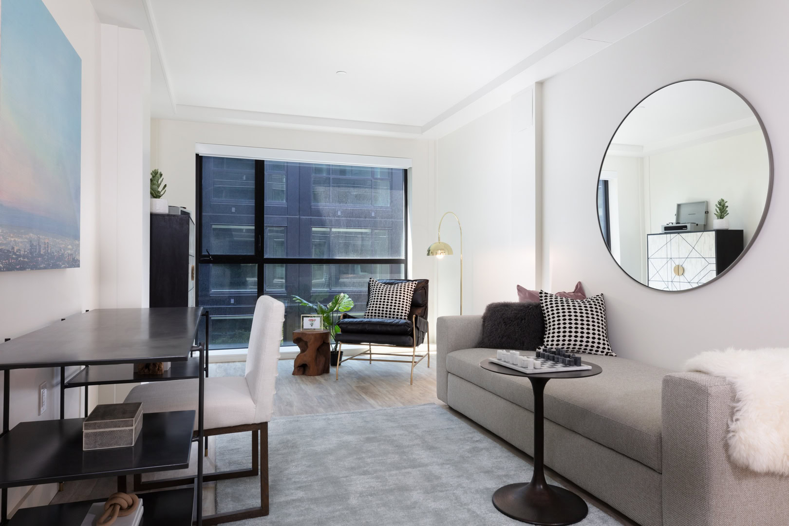 A living room with a work space and floor to ceiling at the Logan apartments in an Oakland luxury apartment