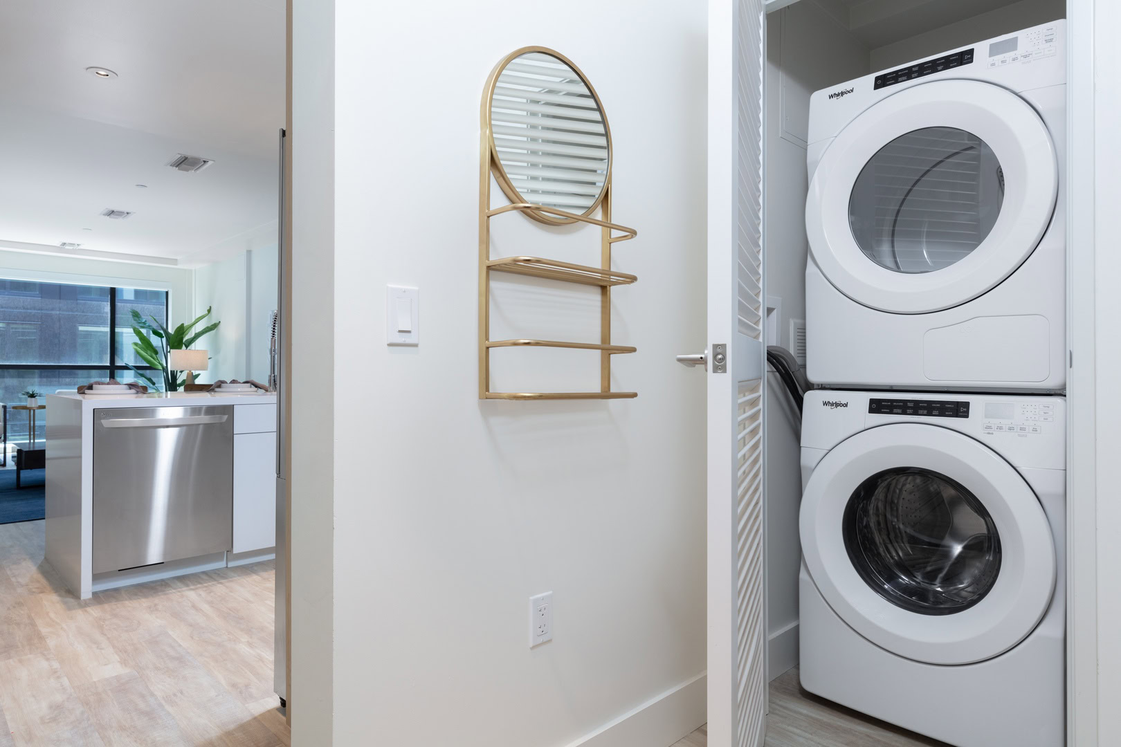 A stacked front loading washing machine and dryer in an apartment at The Logan in Oakland CA