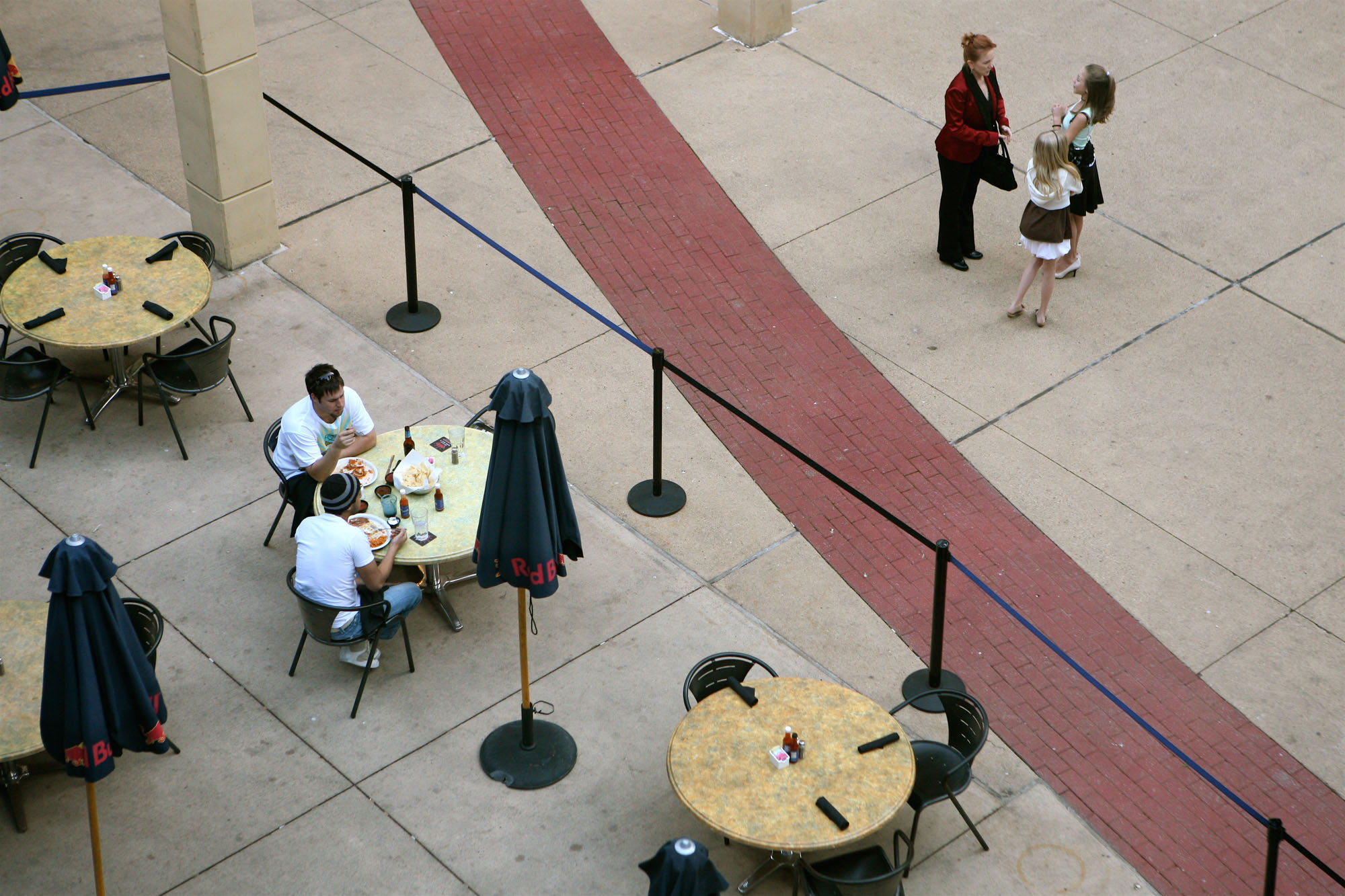 A view of people dining and mingling in the city from The Continental apartments in Dallas, Texas
